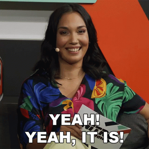 A Woman Is Smiling And Holding A Piece Of Paper That Says Yeah It Is GIF