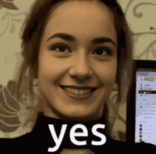 Smiling Woman Holding Yes Sign GIF