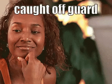 A Woman Is Smiling And Holding Her Finger To Her Chin With The Words `` Caught Off Guard '' Above Her . GIF