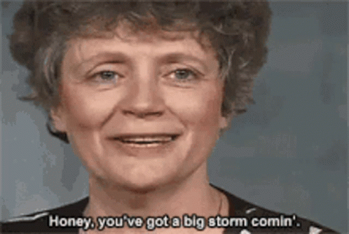 A Woman Is Smiling And Saying " Honey You 'Ve Got A Big Storm Comin " GIF