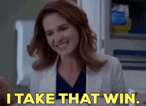 A Woman Is Smiling And Saying `` I Take That Win '' . GIF