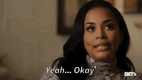 A Woman Is Smiling And Saying `` Yeah ... Okay '' While Sitting On A Couch . GIF