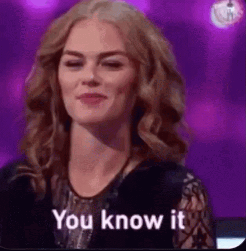 A Woman Is Smiling And Says `` You Know It '' . GIF