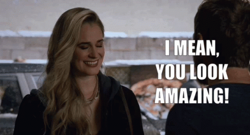 A Woman Is Smiling And Talking To A Man Who Says I Mean You Look Amazing GIF