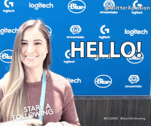 A Woman Is Smiling In Front Of A Blue Background That Says Logitech GIF