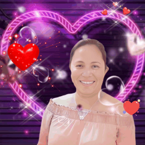 A Woman Is Smiling In Front Of A Heart GIF