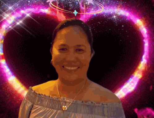 A Woman Is Smiling In Front Of A Purple Heart GIF