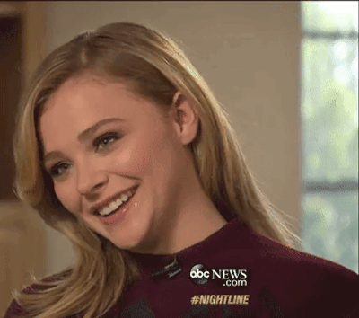 A Woman Is Smiling In Front Of A Screen That Says Abc News.com #Nightline GIF