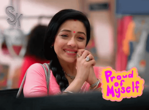A Woman Is Smiling In Front Of A Sign That Reads Proud Of Myself GIF