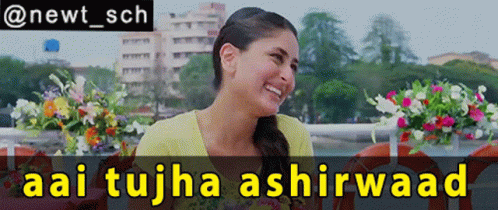 A Woman Is Smiling In Front Of A Sign That Says Aai Tujha Ashirwaad GIF