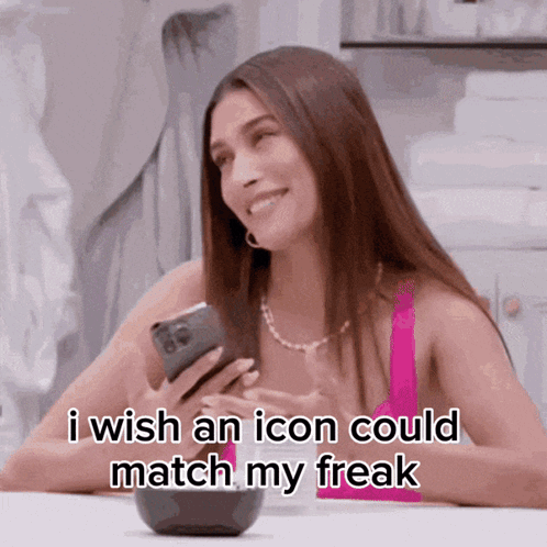A Woman Is Smiling While Holding A Cell Phone And Saying I Wish An Icon Could Match My Freak GIF