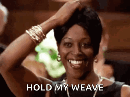 A Woman Is Smiling While Holding Her Hair In Her Hand And Says `` Hold My Weave '' . GIF