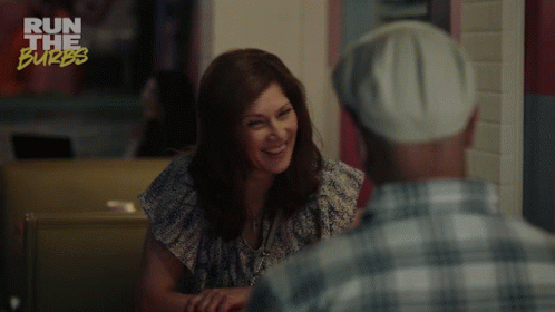 A Woman Is Smiling While Talking To A Man And The Words You 'Re So Funny GIF