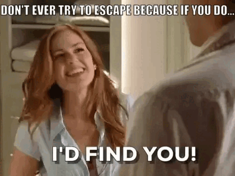A Woman Is Smiling While Talking To A Man In A Room . GIF