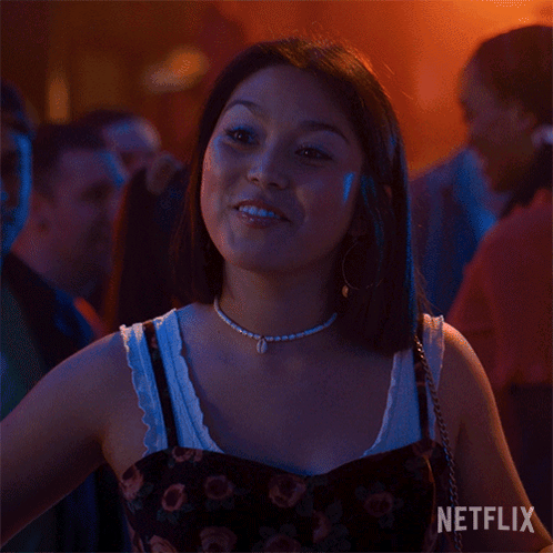 A Woman Is Smiling With A Netflix Logo In The Background GIF