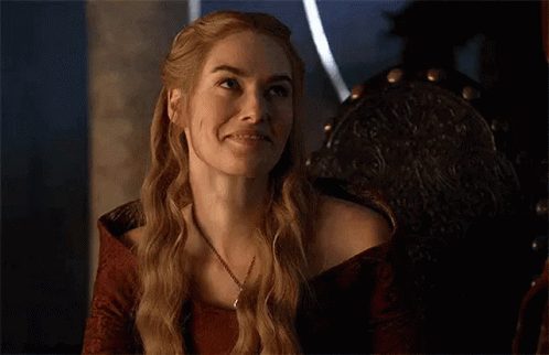 A Woman Is Smiling With Her Eyes Closed While Sitting In A Chair . GIF