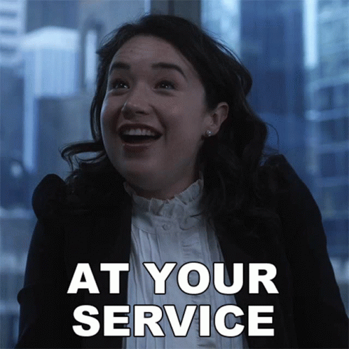 A Woman Is Smiling With The Words At Your Service Written Below Her GIF