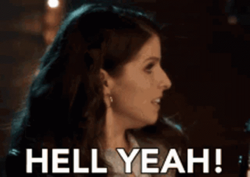 A Woman Is Smiling With The Words Hell Yeah Behind Her GIF
