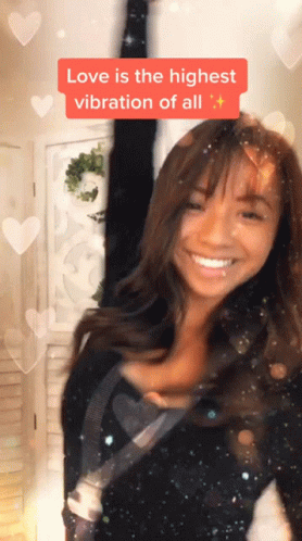 A Woman Is Smiling With The Words Love Is The Highest Vibration Of All Above Her Head GIF