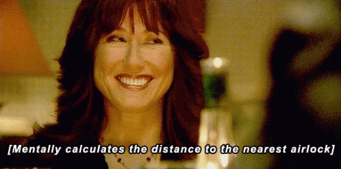 A Woman Is Smiling With The Words Mentally Calculates The Distance To The Nearest Airlock Below Her GIF