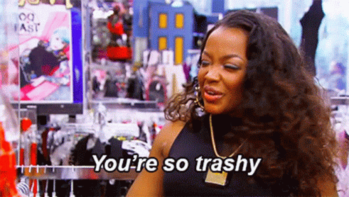 A Woman Is Standing In A Clothing Store And Talking To Someone . GIF