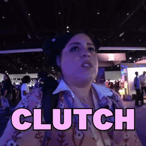 A Woman Is Standing In A Crowd With The Word Clutch Above Her Head GIF