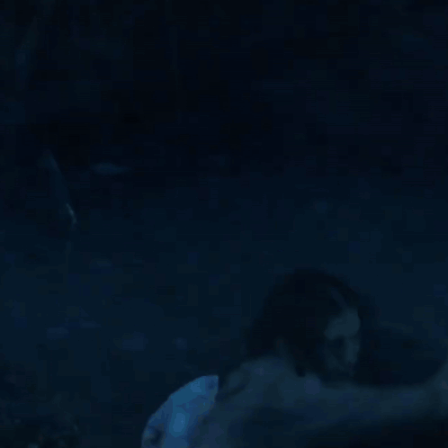 A Woman Is Standing In A Dark Room With Red Smoke Coming Out Of Her Eyes . GIF