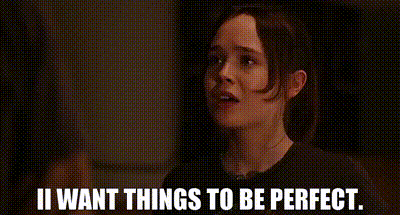 A Woman Is Standing In A Dark Room With The Words `` I Want Things To Be Perfect '' . GIF