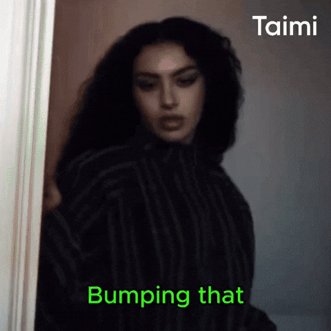 A Woman Is Standing In A Doorway With The Words Bumping That On The Bottom Right GIF