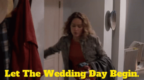A Woman Is Standing In A Hallway With The Words Let The Wedding Day Begin On The Bottom GIF