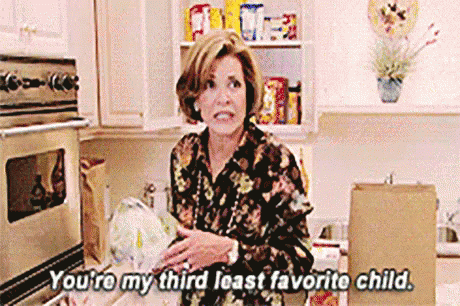 A Woman Is Standing In A Kitchen Holding A Bag Of Food And Talking To Someone . GIF
