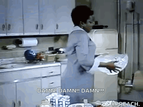 A Woman Is Standing In A Kitchen Holding A Piece Of Paper That Says Damn Damn Damn Damn . GIF