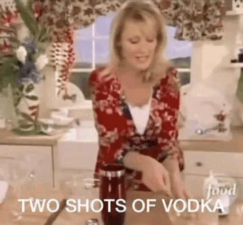 A Woman Is Standing In A Kitchen Preparing A Drink And Says `` Two Shots Of Vodka '' . GIF