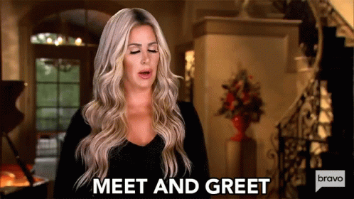 A Woman Is Standing In A Living Room And Says Meet And Greet Bravo . GIF