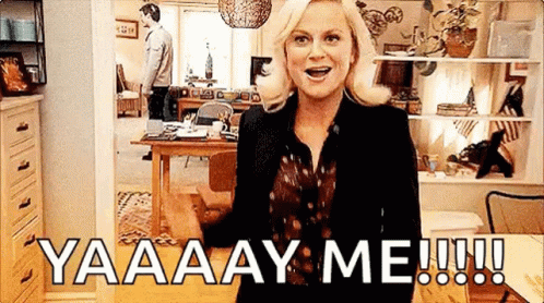 A Woman Is Standing In A Living Room With A Man Standing Behind Her And A Man Standing In The Background . GIF