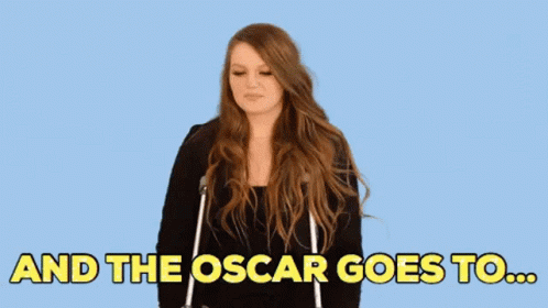 A Woman Is Standing In Front Of A Blue Background And The Oscar Goes To ... GIF