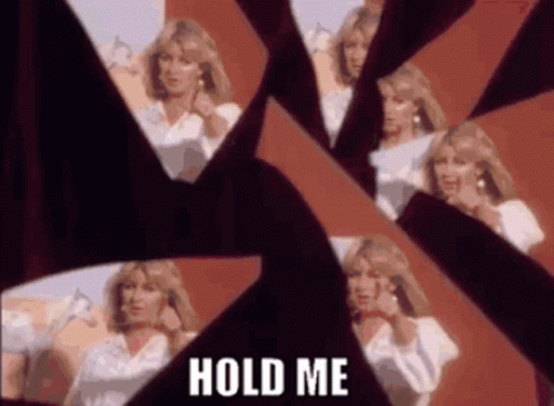 A Woman Is Standing In Front Of A Broken Mirror . GIF