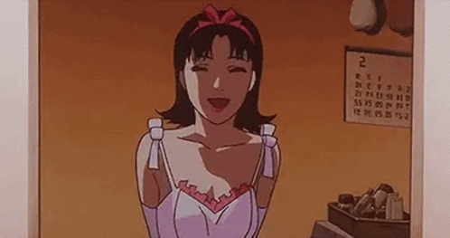 A Woman Is Standing In Front Of A Calendar In A Room . GIF