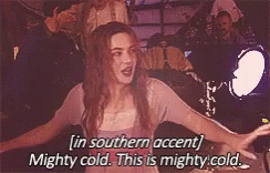 A Woman Is Standing In Front Of A Car With Her Arms Outstretched And Saying In Southern Accent Mighty Cold . GIF