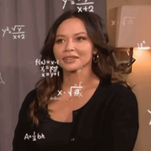 A Woman Is Standing In Front Of A Chalkboard With Mathematical Equations On It GIF