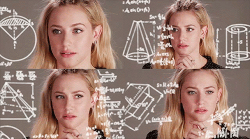 A Woman Is Standing In Front Of A Chalkboard With Mathematical Equations On It GIF