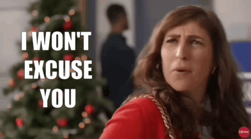A Woman Is Standing In Front Of A Christmas Tree And Saying I Won 'T Excuse You GIF