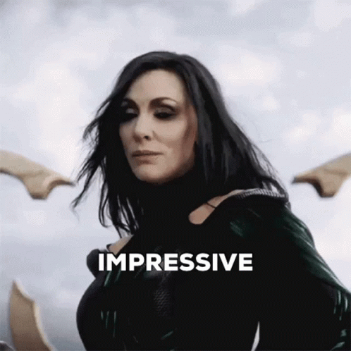 A Woman Is Standing In Front Of A Cloudy Sky And The Word Impressive Is Above Her GIF