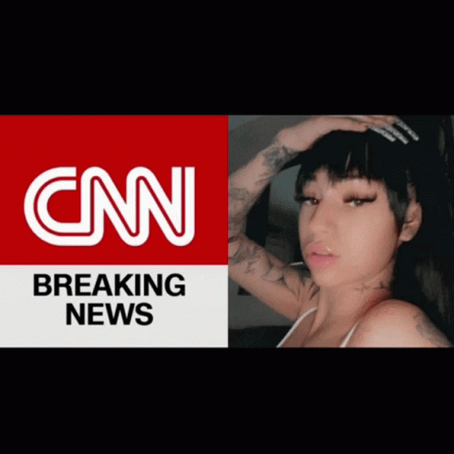 A Woman Is Standing In Front Of A Cnn Breaking News Advertisement GIF