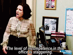 A Woman Is Standing In Front Of A Computer With The Words " The Level Of Incompetence In This Office Is Staggering " Abo GIF