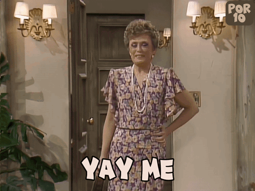 A Woman Is Standing In Front Of A Door And Says Yay Me GIF