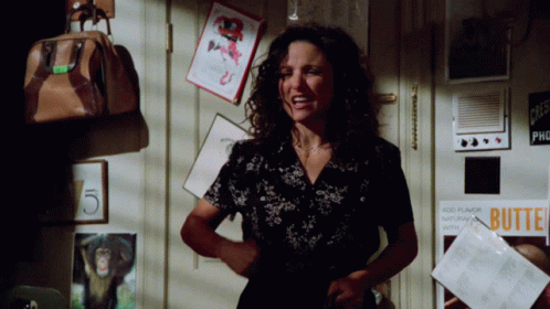 A Woman Is Standing In Front Of A Door With A Sign That Says Butte GIF