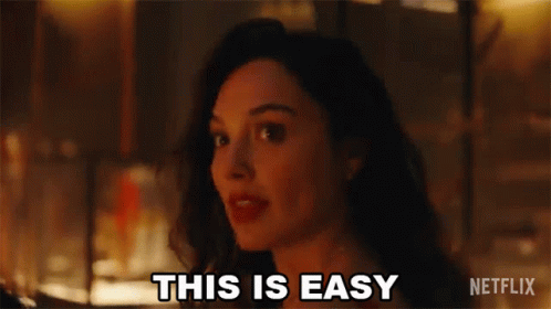 A Woman Is Standing In Front Of A Fire And Saying `` This Is Easy '' . GIF