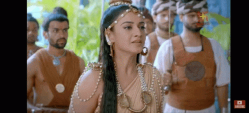 Woman Standing In Front Of Men With Sword GIF