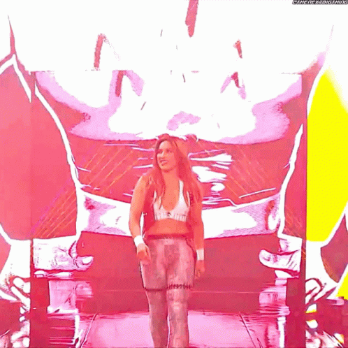 A Woman Is Standing In Front Of A Large Screen That Says Meme-The-Metastar GIF